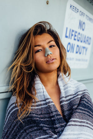 Young woman wearing colorful Nöz SPF sunscreen